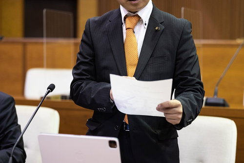 タブレット端末を見ながら紙の資料を使う議員写真素材