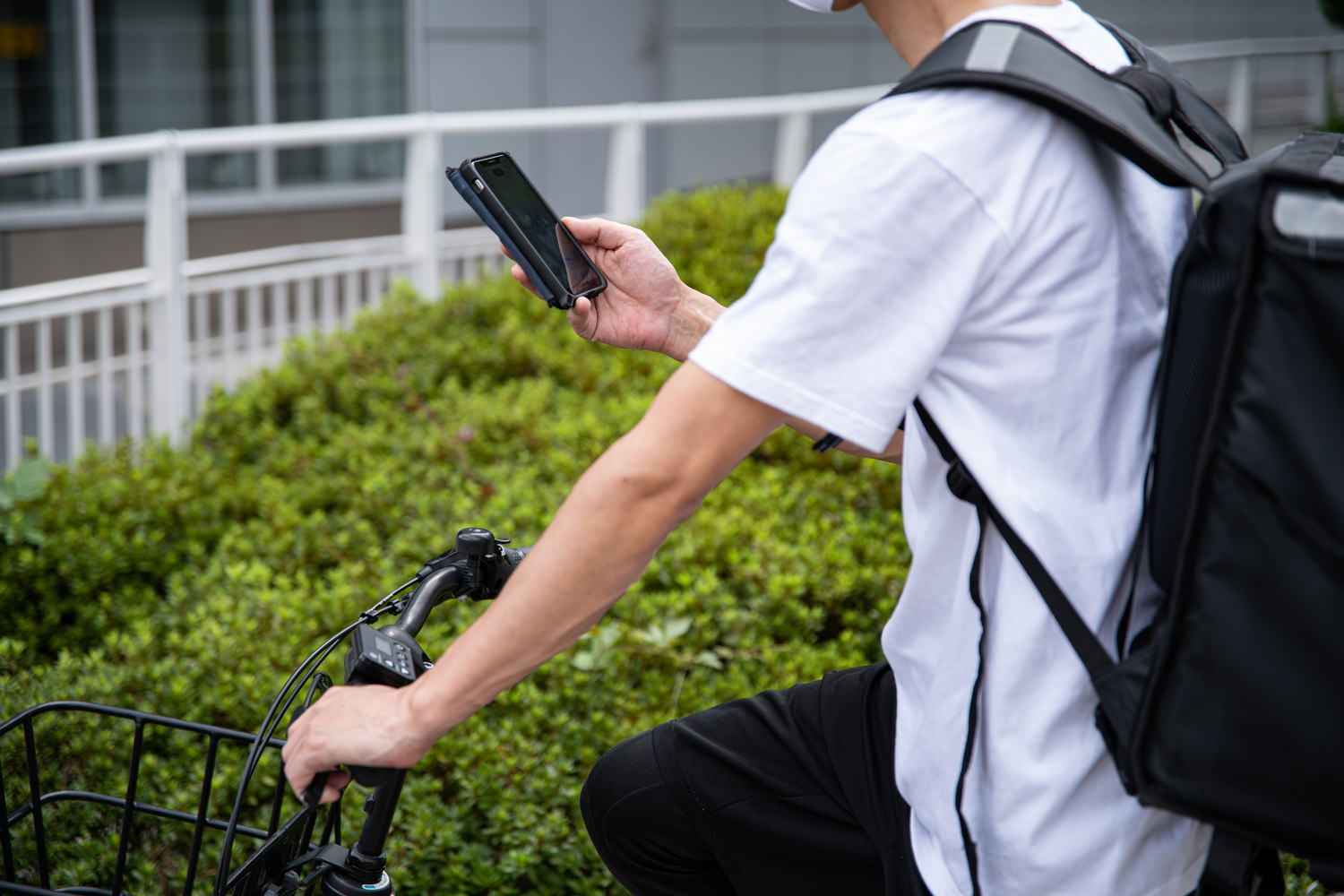 スマホで配達先を調べる配達員の写真素材