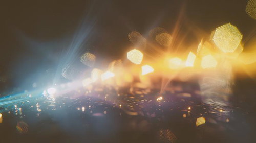 微細な光の粒が交差するボケ味のあるシーン