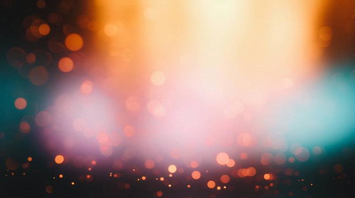 オレンジと青緑に輝く玉ボケの光漏れ|幻想的なグラデーション背景