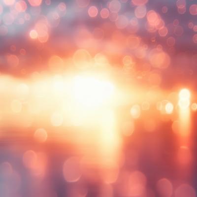 オレンジと黄色の光と玉ボケが重なる抽象背景の写真