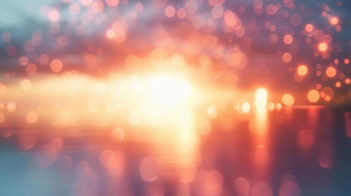 オレンジと黄色の光と玉ボケが重なる抽象背景