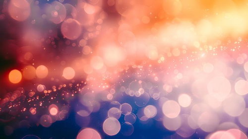 橙色と黄色の光が織りなす玉ボケの光景と煌めく光の粒