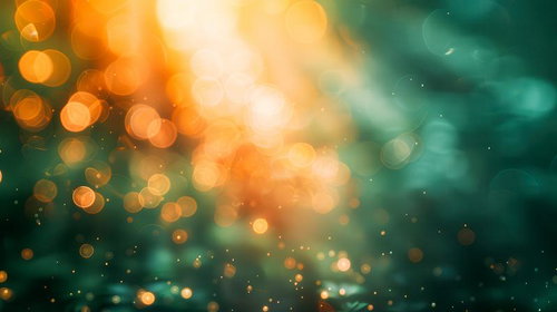 光の輪が広がる緑とオレンジの玉ボケ風景のきらめく光の粒