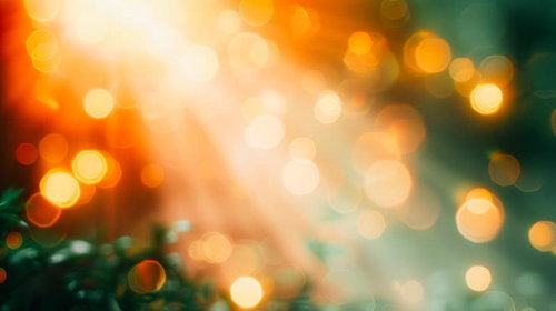 オレンジの光がきらめく幻想的なボケ背景、グリーン色が溶け込む