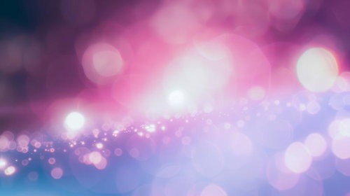 ピンクと紫の光の粒がきらめく夢のような世界
