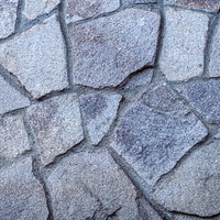 グレー系の不揃いなタイルが敷き詰められた地面テクスチャーの写真