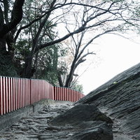 神倉神社の境内、赤い柵沿いに続く石畳の参道の写真