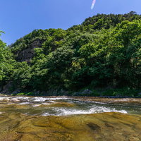 依田川の仙ヶ淵で透明な清流が岩場を流れる景観の写真