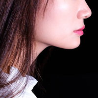 赤い口紅をつけた女性の横顔の写真