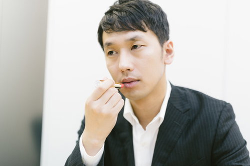 新製品の口紅を試す化粧品会社の男性社員のメンズビューティー