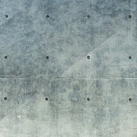 コンクリート打ちっぱなし壁に斜めに残る黒い筋状の跡の写真