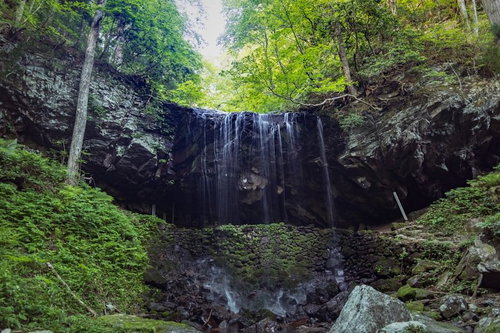 新緑の森に囲まれた岩井滝、滝の裏側から眺める裏見の滝（鏡野町）