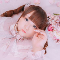 ピンクの花に囲まれて横になるぽちゃかわ女子の写真