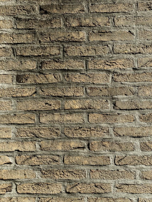 暗い影の残る古い煉瓦壁のテクスチャー