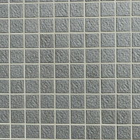 黒いブツブツのある正方形タイル壁のテクスチャの写真