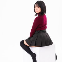 白い四角い椅子に腰を掛けて振り返る女性のポーズの写真