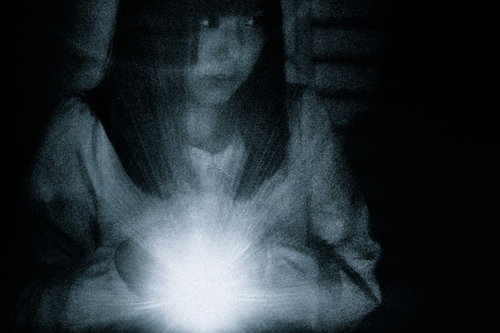 少しずつ、ゆっくり、慎重に、警戒しながら。ライトの光を頼りに暗闇を探索する女性