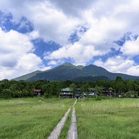 尾瀬の草原から眺める燧ヶ岳と山小屋の絶景登山風景の写真
