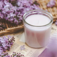 ライラックの花弁を飾ったキャンドルのある空間の写真