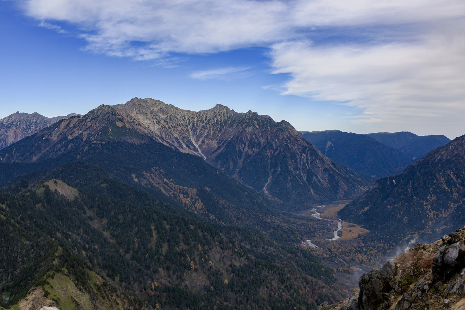 晩秋の穂高岳と上高地の山岳風景、雲が浮かぶ青空と紅葉した森林