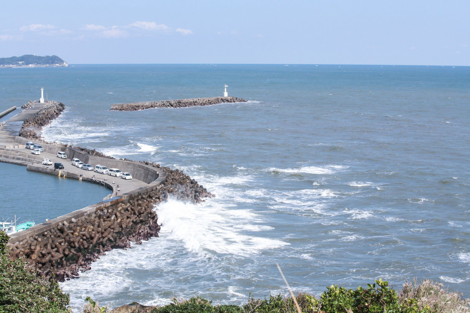 小浜八幡神社からみた外房の防波堤と荒波、灯台のある海の風景