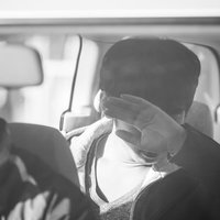 後部座席でフラッシュを浴びる訳あり男性の激写シーンの写真