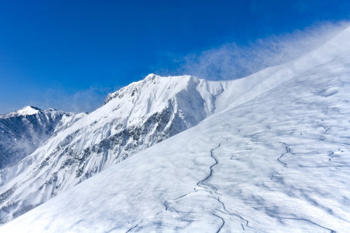 地吹雪が吹き付ける谷川岳中腹と川棚ノ頭方面の冬景色