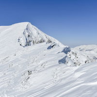 真っ白な雪化粧の谷川岳と一ノ倉岳方面の景色の写真