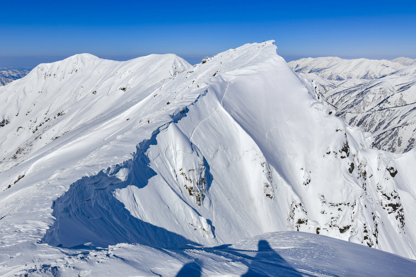 雪に覆われた谷川岳のオキの耳を望む冬山の風景