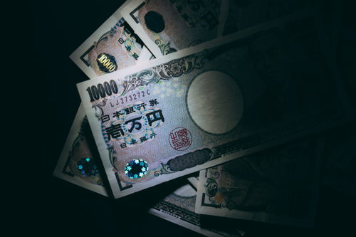 一律に配られた10万円の行方を示す散らばった一万円札