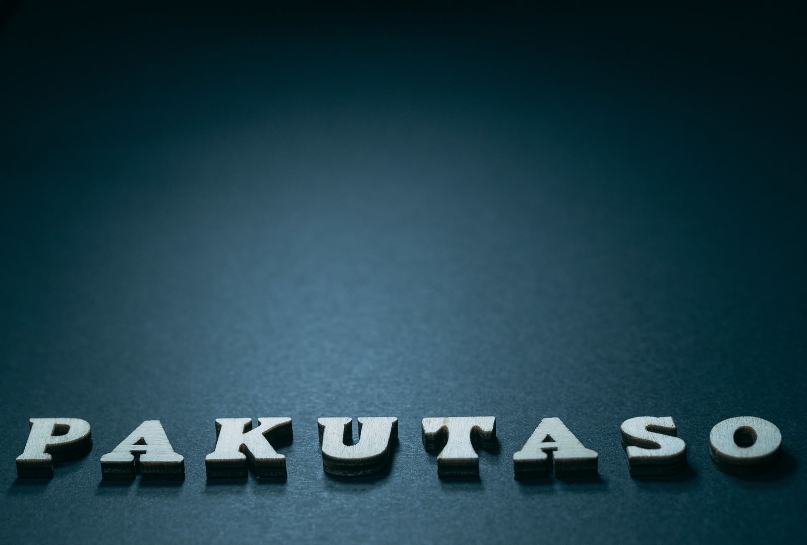 White 3D text of 'PAKUTASO' on a blue gradient background