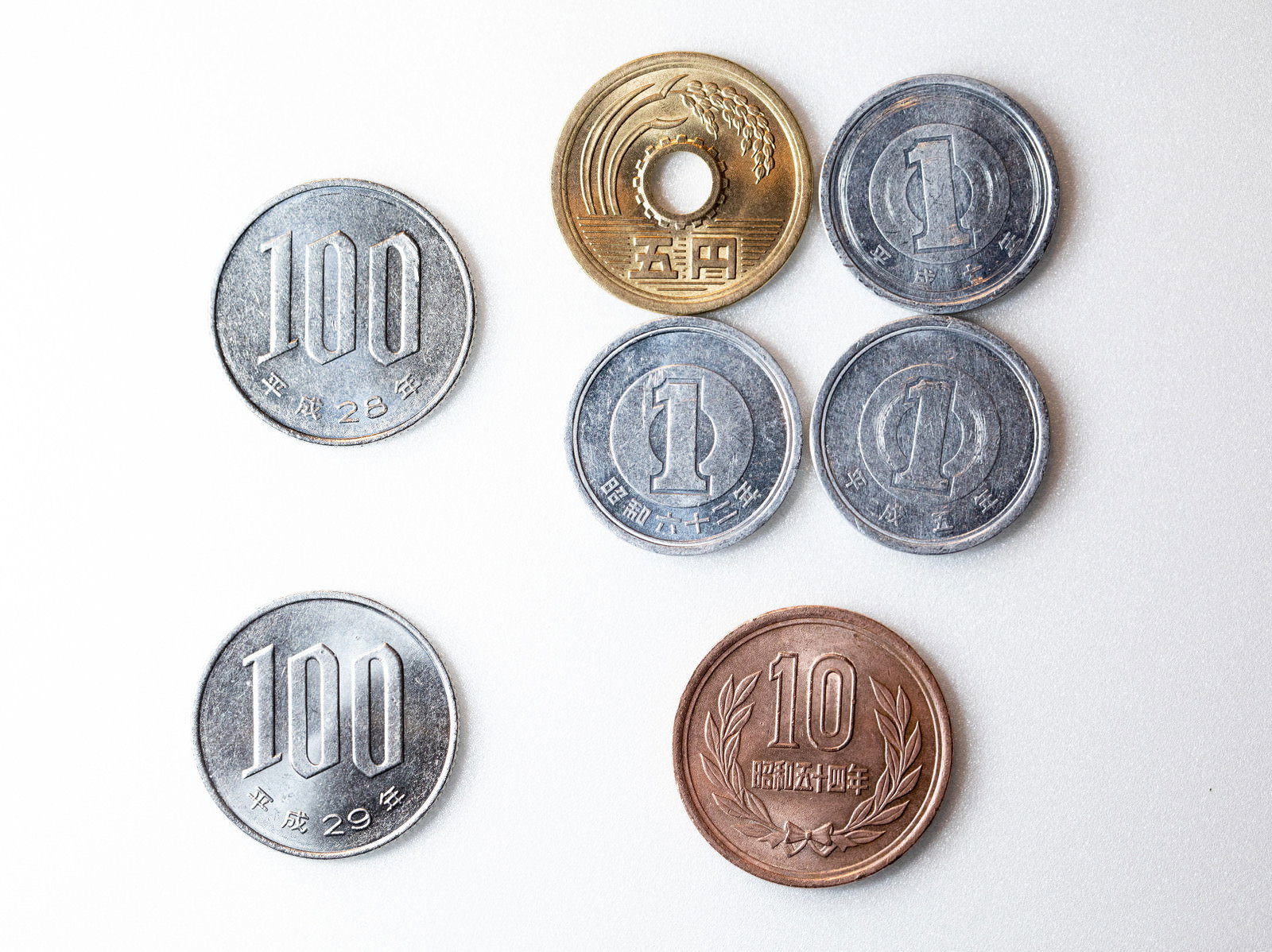 白い背景に配置された100円硬貨、50円硬貨、10円硬貨、5円硬貨、1円硬貨