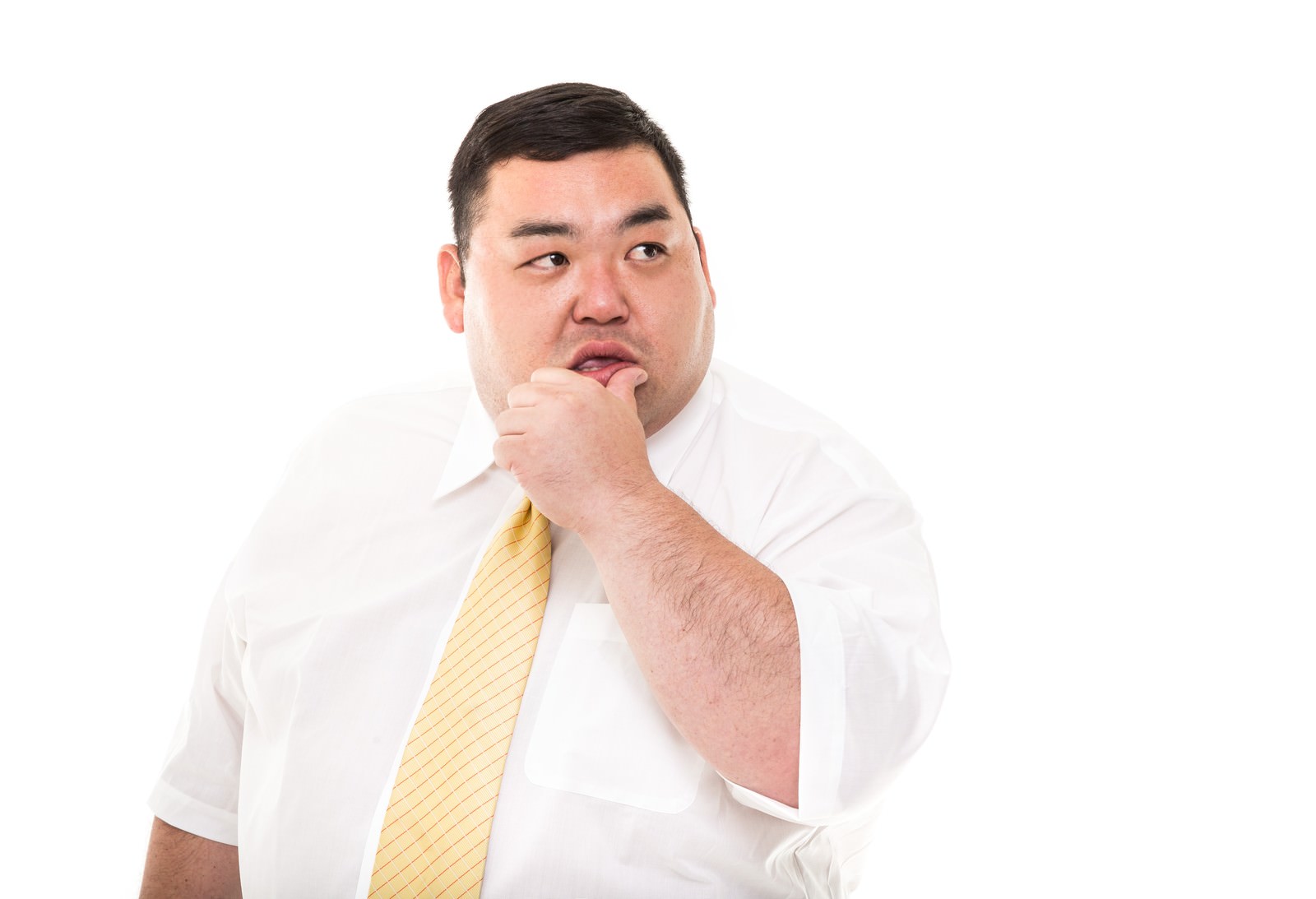 スーツ姿で闘志を表現する男性が指を口に当てている［モデル：横山ともや］