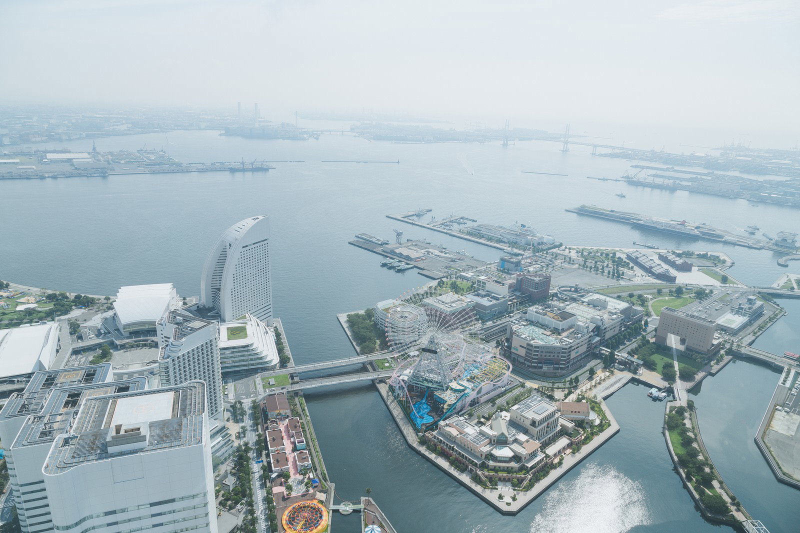高層ビルが立ち並ぶ横浜みなとみらいと停泊する大型船舶が見える港湾風景