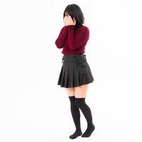 両手で顔を覆う赤いトップスのハイソックス女性の写真