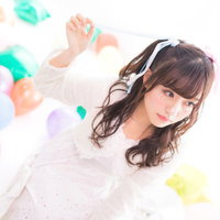 白い衣装のツインテール、髪のリボンを解く女性アイドルの写真