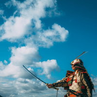 青空を背景に日本刀を掲げる大鎧姿の勇敢な武士の写真