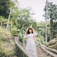燈籠坂大師の石段を下りる麦わら帽子の女性の写真