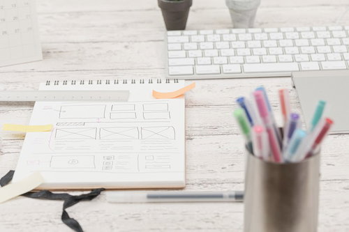 デスクに広げた色付き付箋が張られたメモ用紙