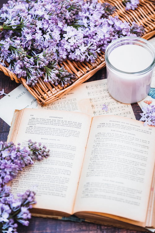 ラベンダーの生花とライラックが彩る洋書とキャンドル