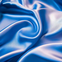 青いサテン生地が描く光沢のある優雅な曲線の写真
