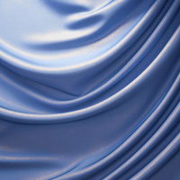 光沢を放つ波打つ青いサテン生地のドレープテクスチャーの写真