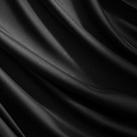 黒い布の波打つような動きと光沢を捉えたサテン生地の写真