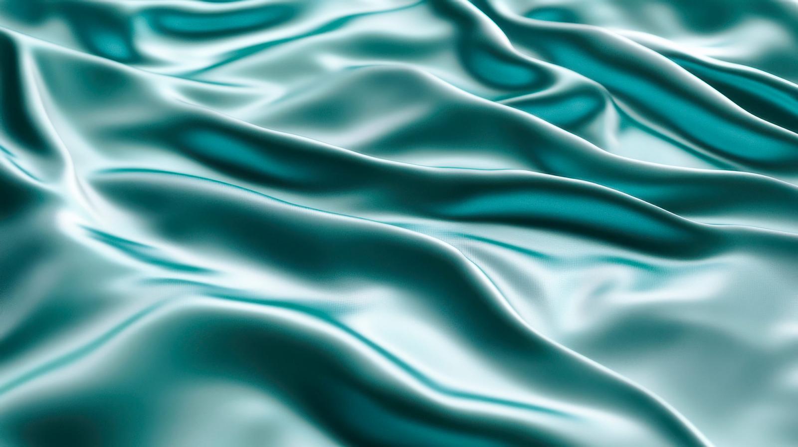 エメラルドグリーンの光沢があり波状にドレープした布地