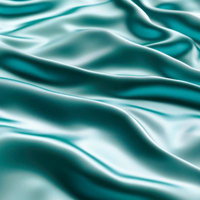 エメラルドグリーンの光沢のある滑らかな布地のドレープの写真