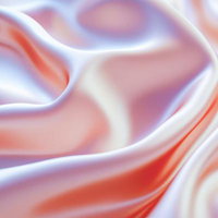 しなやかに波打つ淡いピンク色のシルク生地の写真