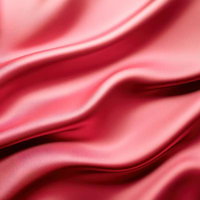 鮮やかなローズピンクのサテン生地の流れるようなドレープの写真