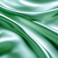 柔らかく波打つミントグリーンのサテン生地の光沢の写真