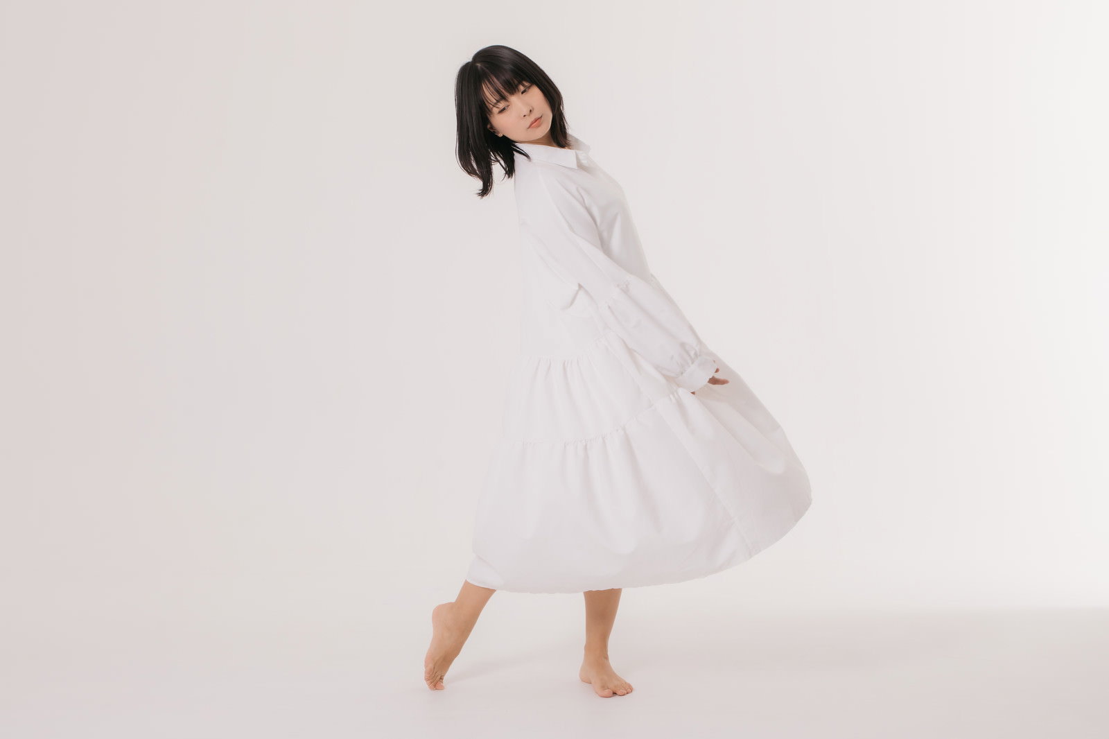 白いワンピースを着て左右に体を揺らす女性の全身ポーズ［モデル：にゃるる］